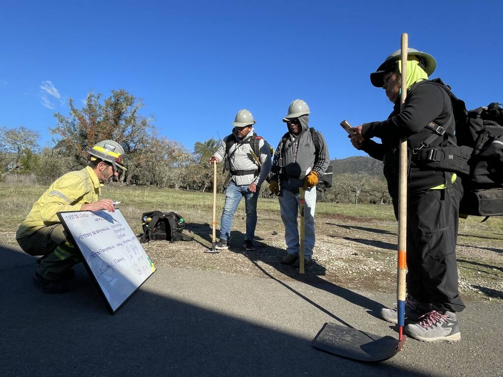 Duce coaches Sonoma County farmworkers about the three factors to a fire – heat, oxygen and fuel – and how to stop each factor at the Bouverie Preserve in Glen Ellen on Tuesday, Dec. 13. (Chase Hunter/