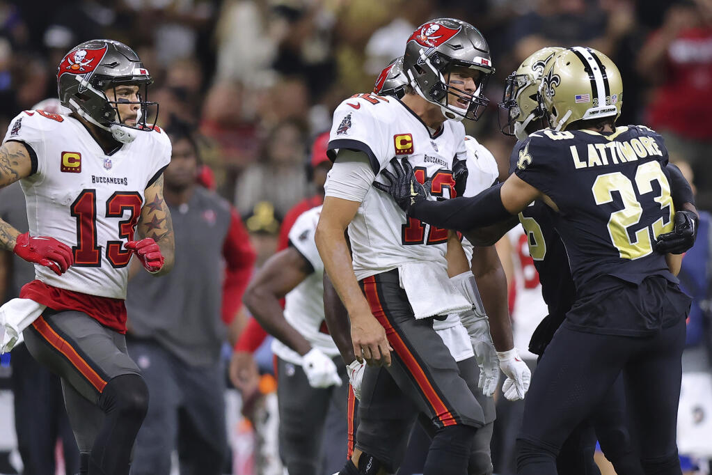 Tampa Bay Buccaneers wide receiver Mike Evans (13), quarterback Tom Brady (12) and New Orleans Saints cornerback Marshon Lattimore (23) get into an altercation during the second half of an NFL football game, Sunday, Sept. 18, 2021, in New Orleans. (AP Photo/Jonathan Bachman)