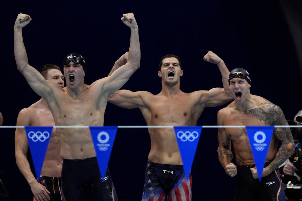 The United States' men's 4x100-meter medley relay team, from left, Ryan Murphy, Zach Apple, Michael Andrew and Caeleb Dressel, celebrate winning the gold medal at the 2020 Summer Olympics, Sunday, Aug. 1, 2021, in Tokyo, Japan. (AP Photo/Gregory Bull)