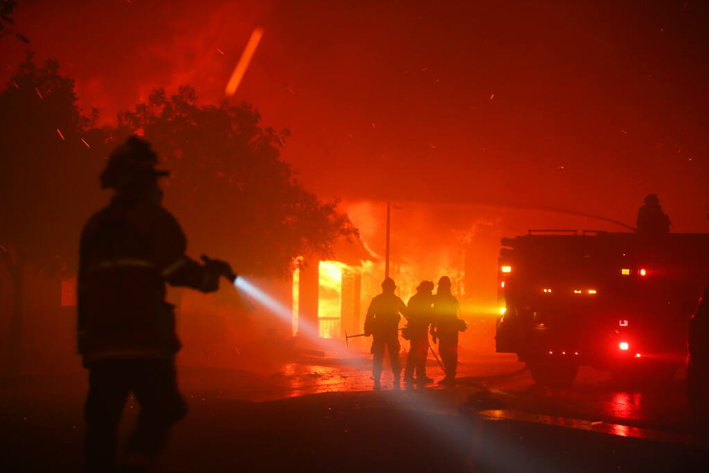 Firefighters work on slowing the spread of flames as the Shady fire takes out homes on Mountain Hawk Drive in Santa Rosa early Monday morning, September 28, 2020.  (Christopher Chung/ The Press Democrat)