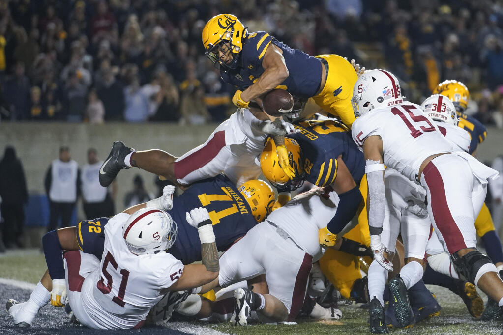 Cal running back Jaydn Ott, top, fumbles the ball while attempting to dive into the end zone against Stanford during the second half Saturday in Berkeley. Cal recovered the ball. (Godofredo A. Vásquez / ASSOCIATED PRESS)