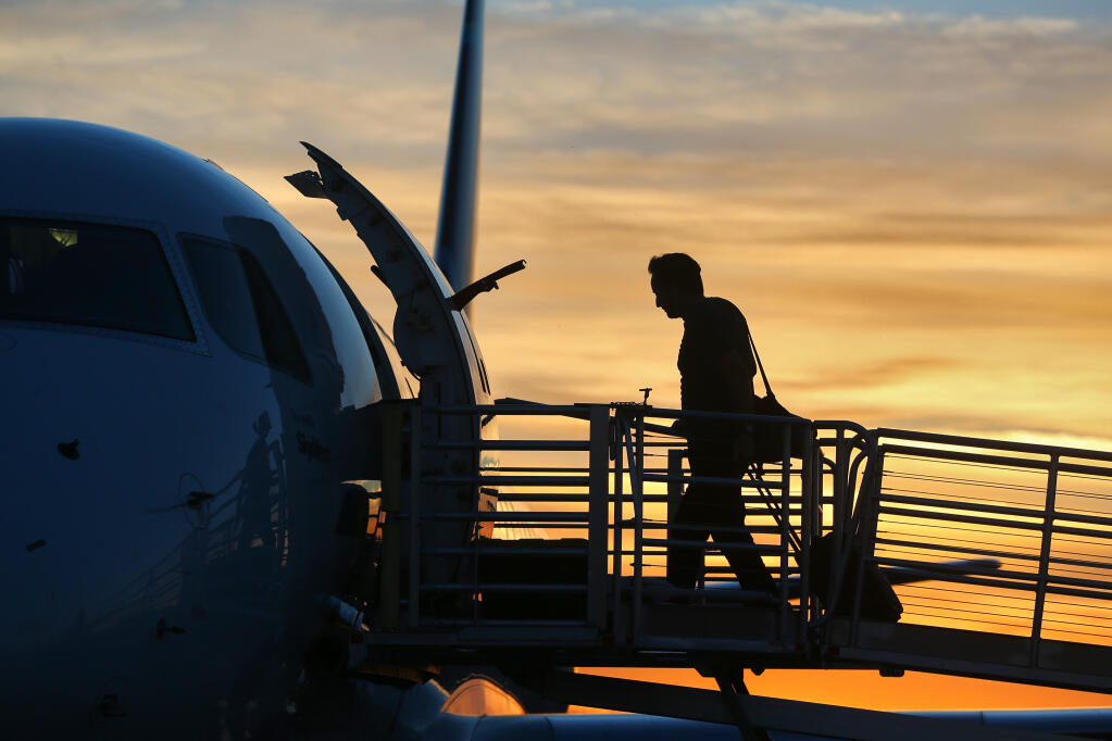 A traveler boards a plane at the Charles M. Schulz-Sonoma County Airport in Santa Rosa, Thursday, Nov. 10, 2022.  (Christopher Chung/The Press Democrat file)