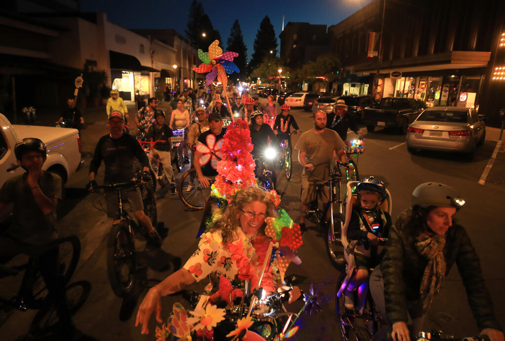 Kris Culp of Santa Rosa stops with others on Fourth St. in Santa Rosa during the Taco Tuesday bike ride, May 31, 2022. (Kent Porter / The Press Democrat) 2022