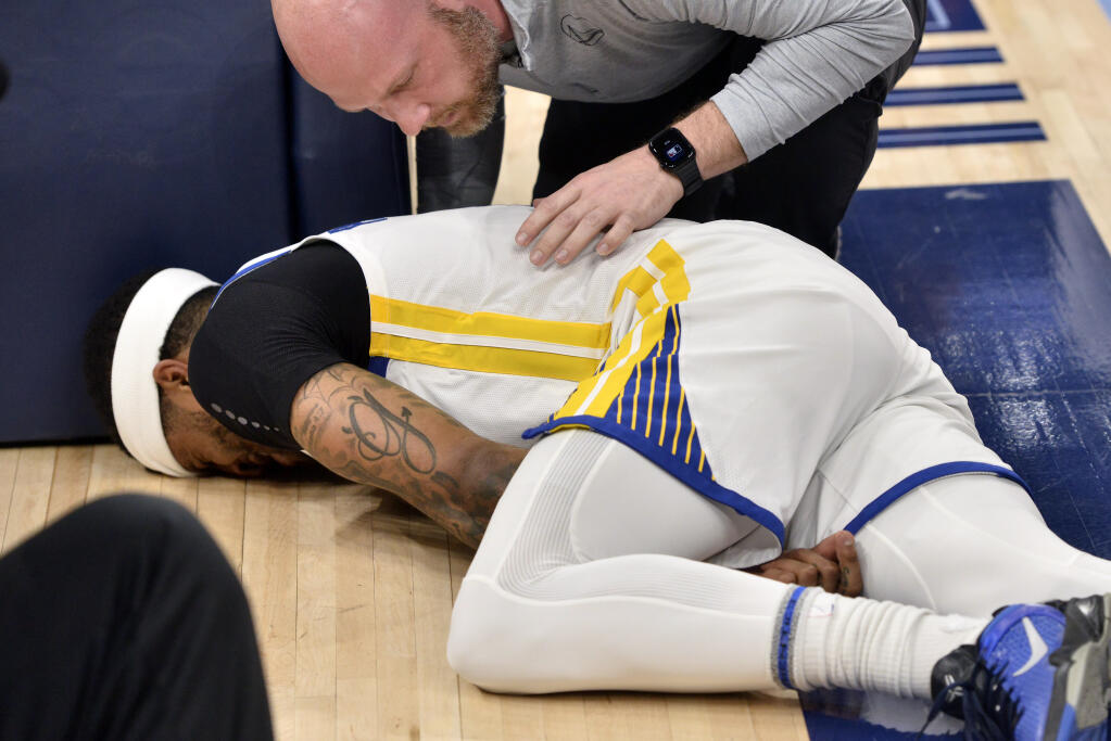 Warriors guard Gary Payton II lies on the court after being fouled during the first half of Game 2 of the team’s second-round playoff series against the Grizzlies on Tuesday, May 3, 2022, in Memphis, Tennessee. (Brandon Dill / ASSOCIATED PRESS)