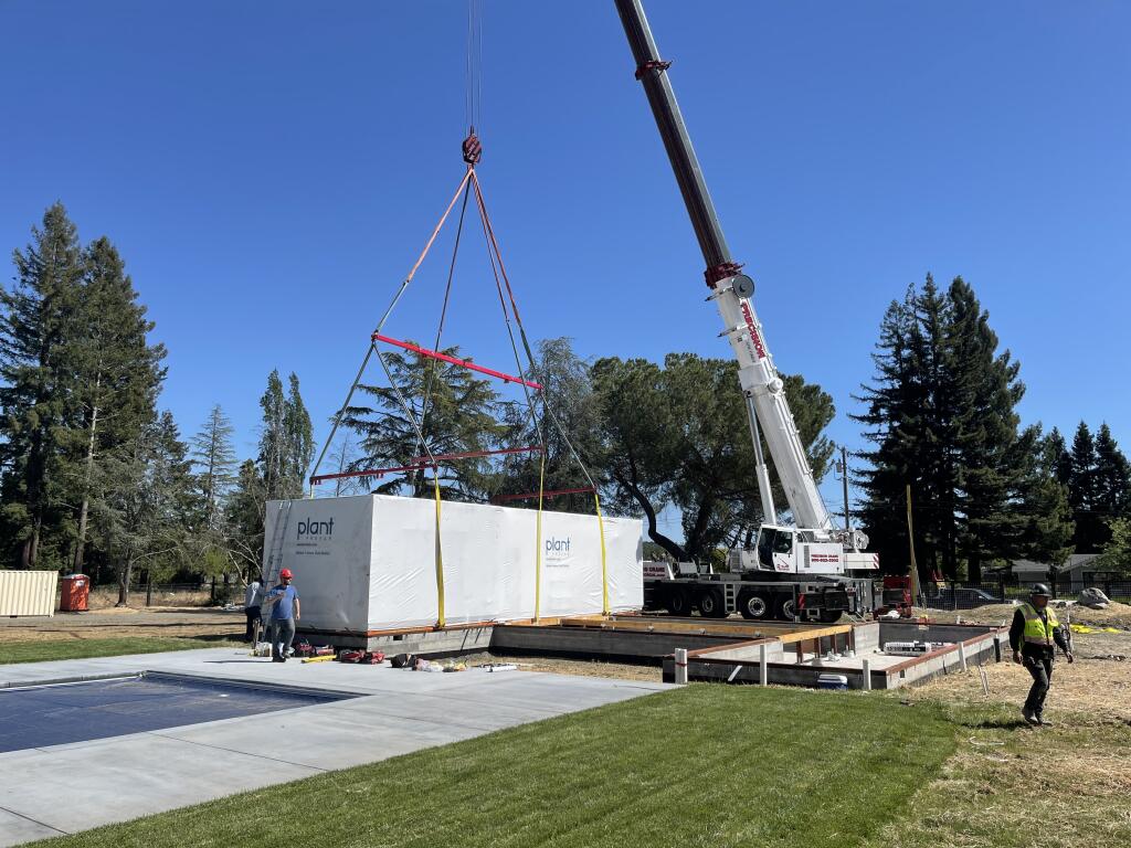 A Plant Module being set on the foundation in Kenwood. The modules were shipped complete with interior and exterior finishes for minimal on-site finish work. | Courtesy of Plant Prefab