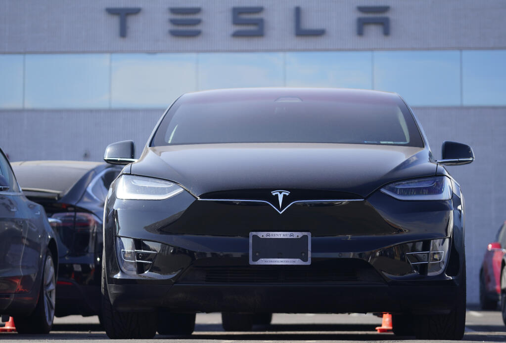 FILE - An unsold 2021 Model X sports-utility vehicle sits at a Tesla dealership Sunday, Jan. 24, 2021, in Littleton, Colo.  (AP Photo/David Zalubowski)