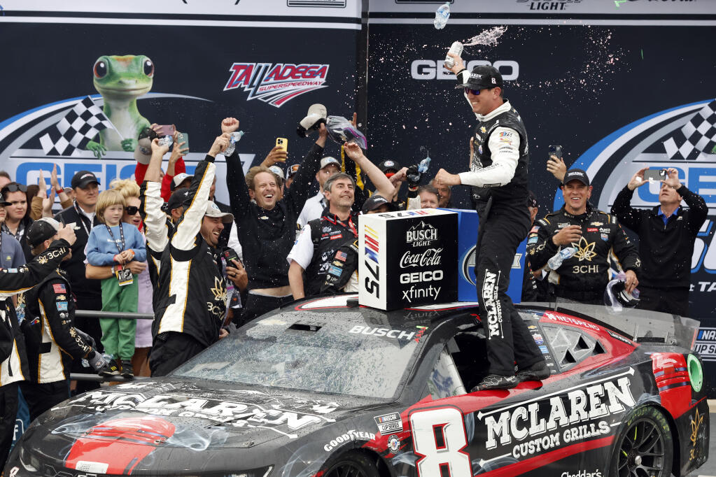 Kyle Busch, front right, celebrates in Victory Lane after winning a NASCAR Cup Series auto race at Talladega Superspeedway, Sunday, April 23, 2023, in Talladega, Ala. (AP Photo/Butch Dill)