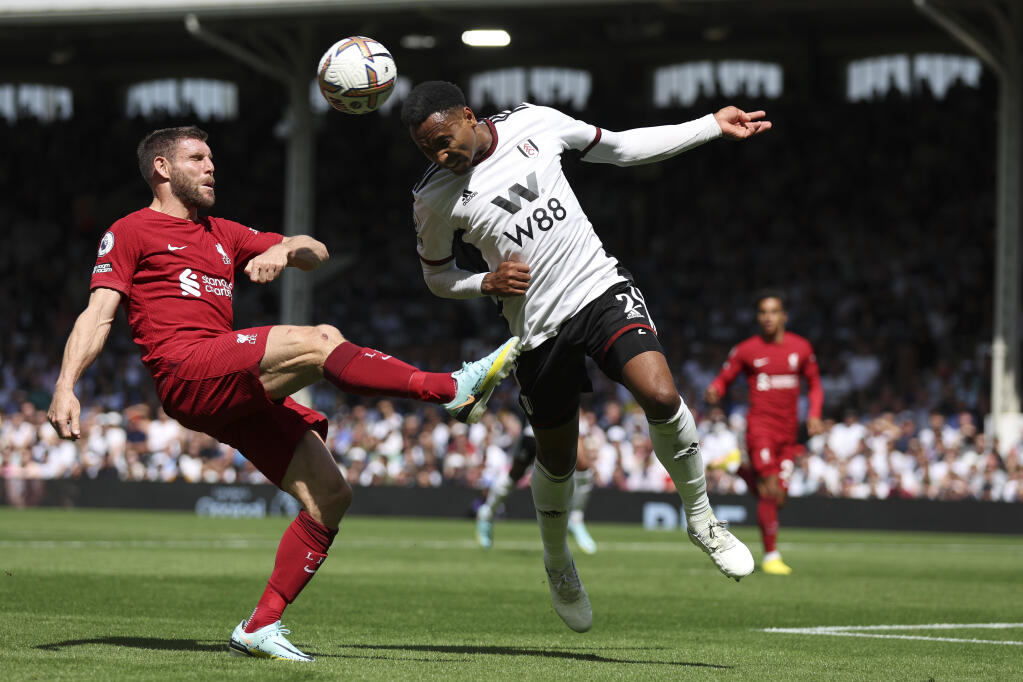 Liverpool’s James Milner, left, and Fulham’s Kenny Tete vie for the ball during the English Premier League match at Craven Cottage stadium Saturday, Aug. 6, 2022, in London. (Ian Walton / ASSOCIATED PRESS)