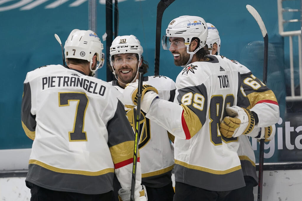 Vegas Golden Knights right wing Alex Tuch, right, celebrates with teammates after scoring a goal against the San Jose Sharks during the second period in San Jose on Saturday, March 6, 2021. (Jeff Chiu / ASSOCIATED PRESS)