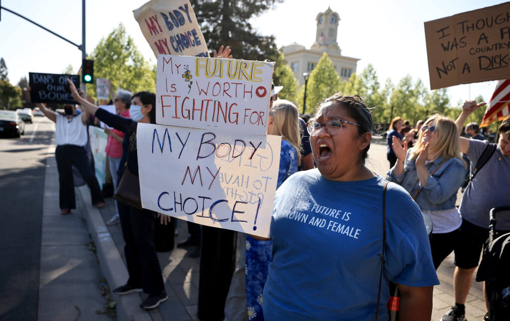 Naomi Lossy of Cotati, 18, of Cotati, gathers with others at Old Courthouse Square in Santa Rosa, Tuesday, May 3, 2022 to protest the Supreme Court's leaked documents of overturning Roe v Wade. (Kent Porter / The Press Democrat) 2022