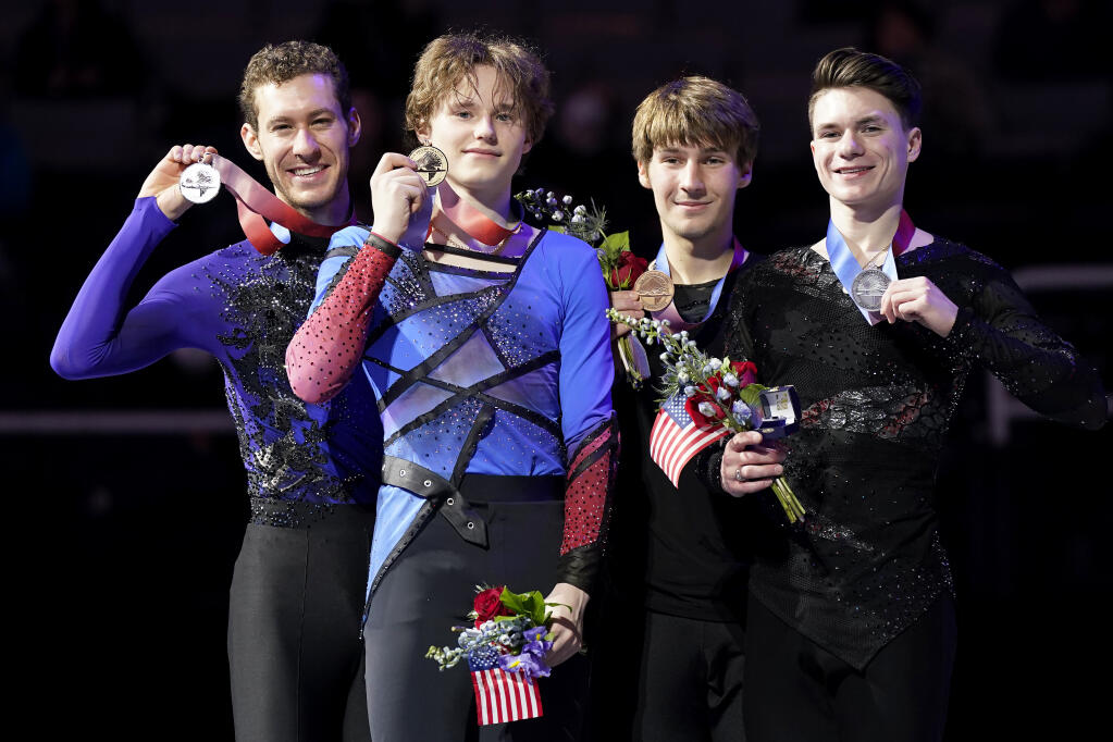 Jason Brown, Ilia Malinin, Andrew Torgashev and Maxim Naumov, from left, hold their medals after the men's free skate at the U.S. figure skating championships in San Jose, Calif., Sunday, Jan. 29, 2023. Malinin finished first, Brown finished second, Torgashev finished third and Naumov finished fourth in the event. (AP Photo/Tony Avelar)