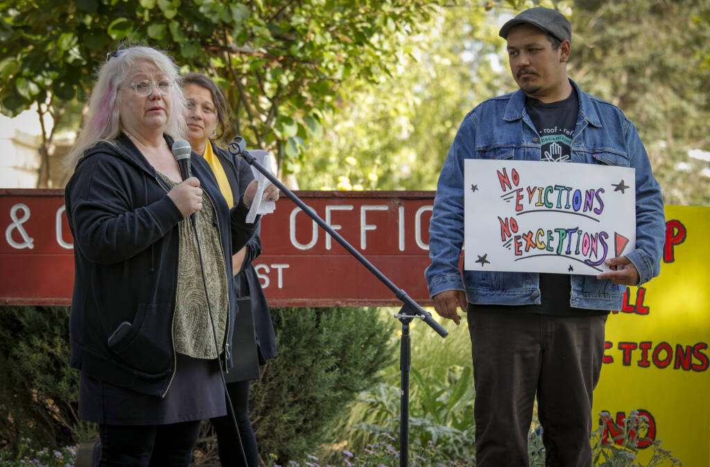 Brooke Arteaga speaks to the crowd of protesters outside of City Hall about her experience with evictions and the high cost of housing in Petaluma. Karym Sanchez (right) of the North Bay Organizing Project stands by to provide Spanish translation. _Monday, May 02, 2022._Petaluma, CA, USA. _(CRISSY PASCUAL/ARGUS-COURIER STAFF)