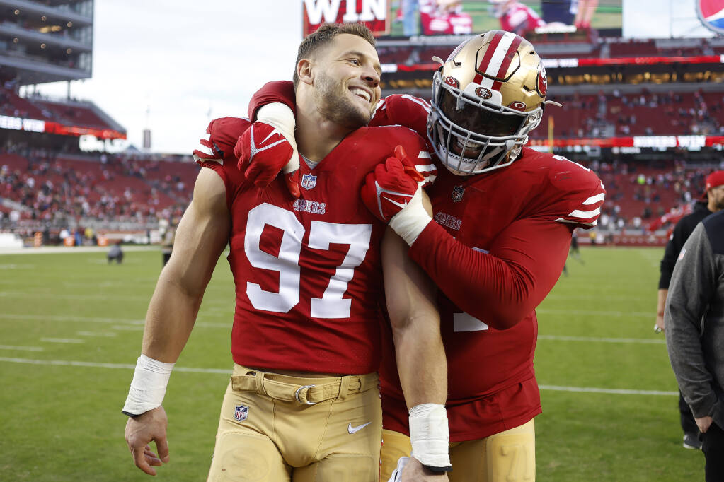 49ers defensive end Nick Bosa celebrates with offensive tackle Trent Williams after defeating the New Orleans Saints on Sunday in Santa Clara. (Jed Jacobsohn / ASSOCIATED PRESS)