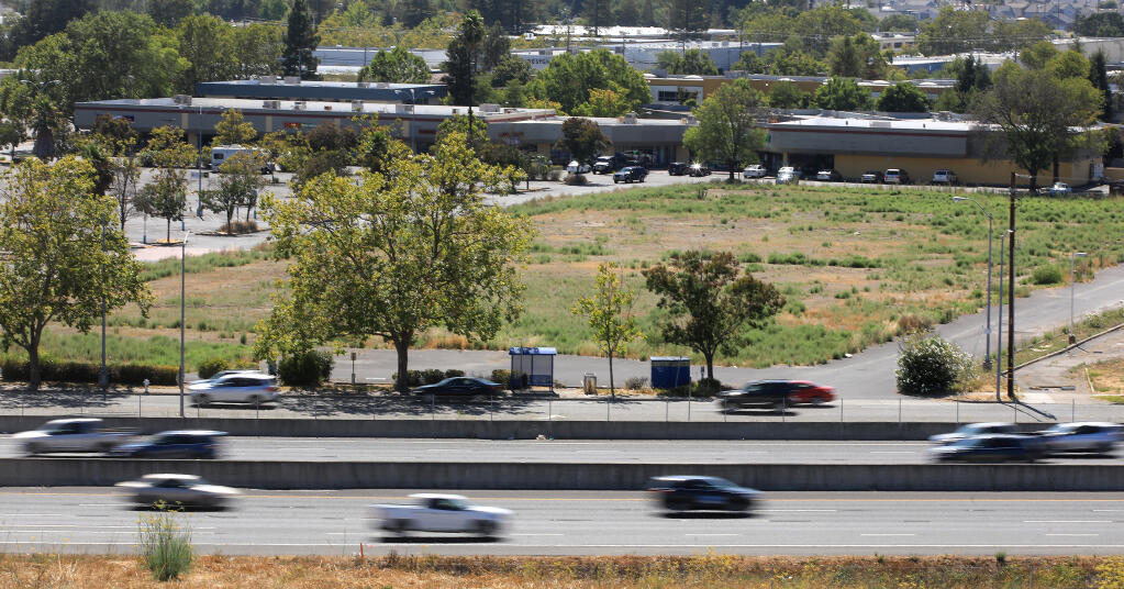 Freeway traffic zooms past, Wednesday, Aug. 5, 2020, by the lot where Kmart used to stand before it was destroyed by the 2017 Tubbs fire. The Sonoma County Indian Health Project has announced plans to open a 70,000-square-foot medical center on the land. (Kent Porter / The Press Democrat) 2020