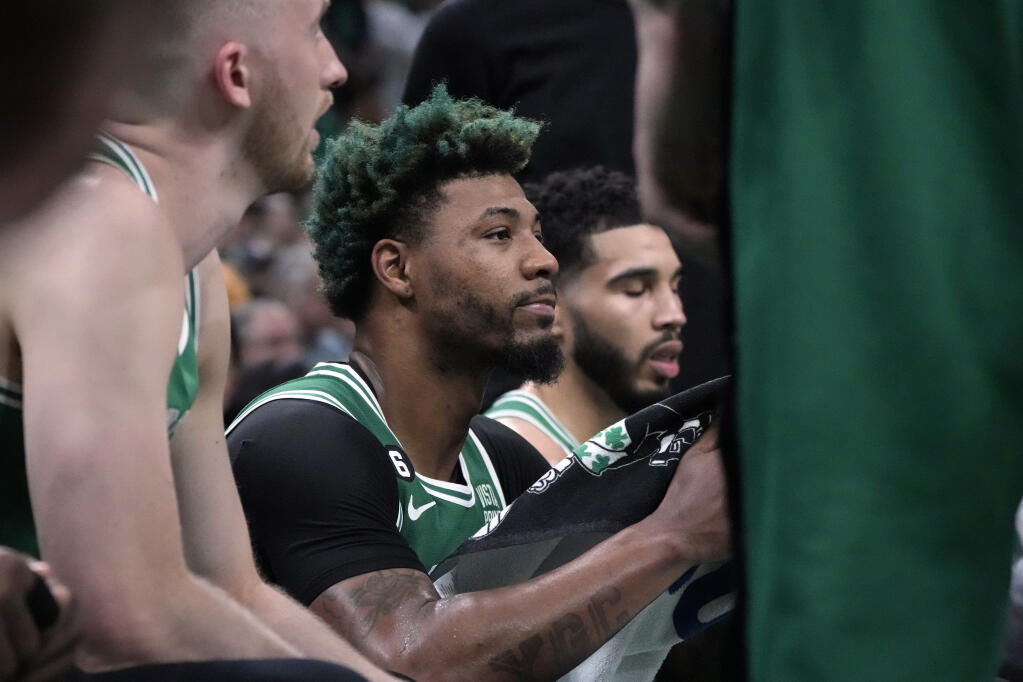 Boston Celtics guard Marcus Smart sits during a timeout in the second half in Game 7 of the NBA basketball Eastern Conference finals against the Miami Heat Monday, May 29, 2023, in Boston. (AP Photo/Charles Krupa )