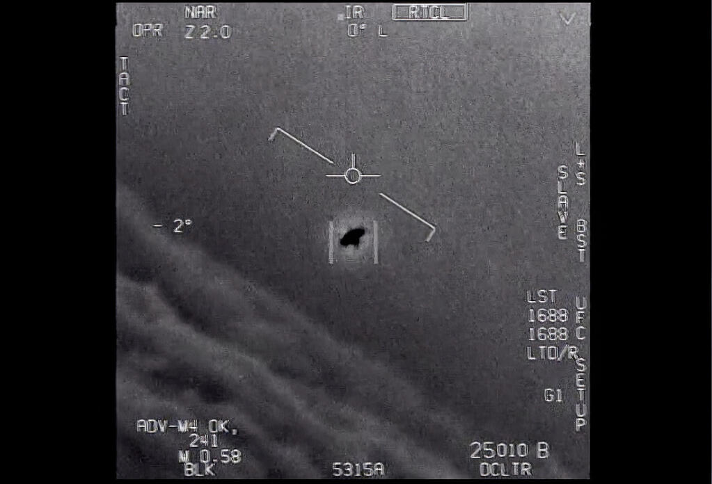 The image from video provided by the Department of Defense labelled Gimbal, from 2015, an unexplained object is seen at center as it is tracked as it soars high along the clouds, traveling against the wind. “There's a whole fleet of them,” one naval aviator tells another, though only one indistinct object is shown. “It's rotating." The U.S. government has been taking a hard look at unidentified flying objects, under orders from Congress, and a report summarizing what officials know is expected to come out in June 2021. (Department of Defense via AP)