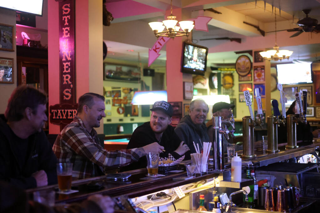 Patrons enjoy drinks and appetizers at the bar at Steiners Tavern in Sonoma, Calif., on Tuesday, Dec. 21, 2021. (Beth Schlanker/The Press Democrat)