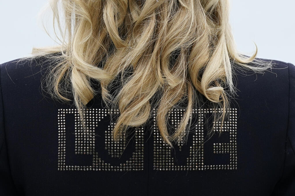 First lady Jill Biden turns around to show the word "love" on the back of her jacket as she speaks with reporters after visiting with Carrie Johnson, wife of British Prime Minister Boris Johnson, ahead of the G-7 summit, Thursday, June 10, 2021, in Carbis Bay, England. (AP Photo/Patrick Semansky)