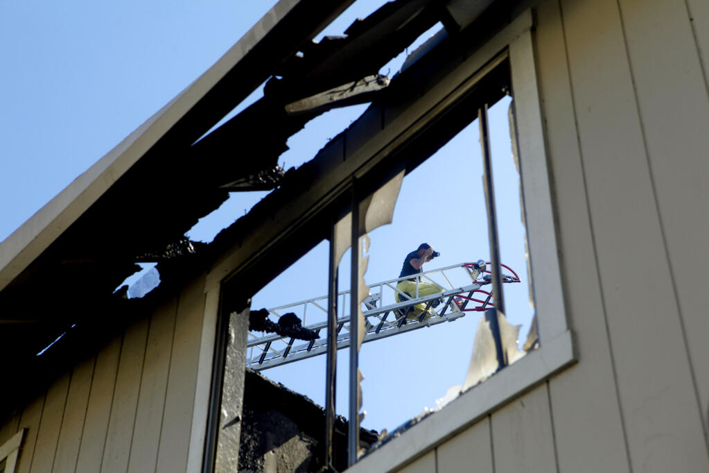 Rohnert Park’s fire marshal inspects the damage to a local apartment complex following a July 4, 2011 fire attributed to illegal fireworks. Thirty-two people were left homeless by the fire. (BETH SCHLANKER / The Press Democrat)