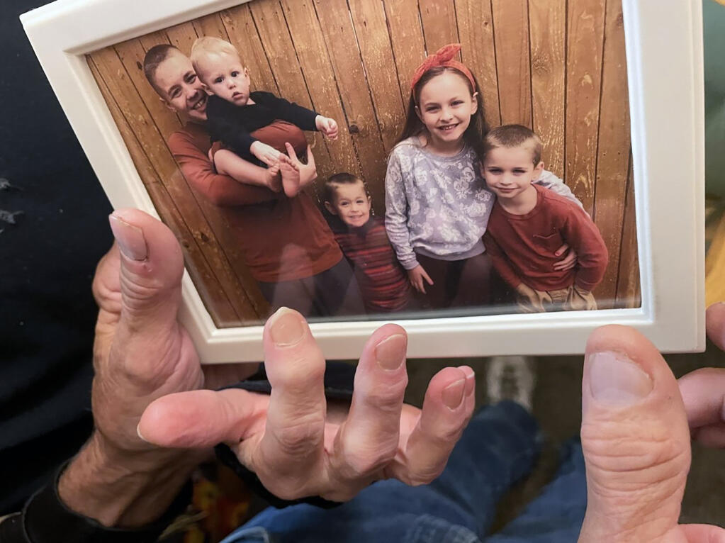 FILE - From left, Brian Anthony Nelson II, Kurgan Nelson, Ragnar Nelson, Brantley Nelson and Vegeta Nelson are seen in a framed photograph in their grandparents apartment in Tulsa, Okla., Oct. 28, 2022. All six children perished on Oct. 27, in what Broken Arrow, Okla., Police suspect was a murder-suicide by their parents, Brian and Brittney Nelson. Preliminary autopsy reports show eight members of a Broken Arrow family found dead inside their burning home were each shot. The bodies of Brian Nelson, 34, his wife Brittney Nelson, 32, and their six children were found in October 2022 inside the burning home in what police at the time called a murder-suicide. (Andrea Eger/Tulsa World via AP, File)