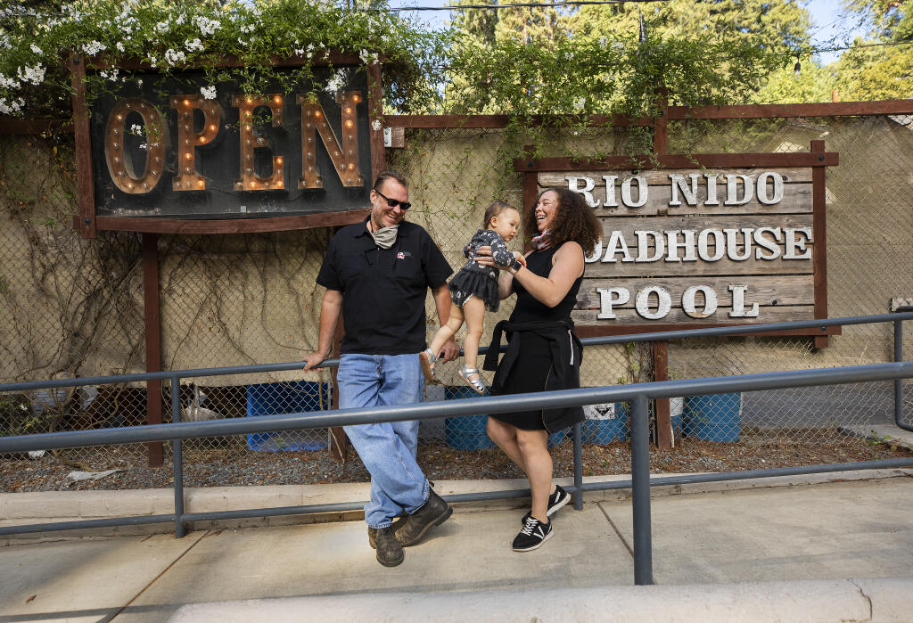 Rio Nido Roadhouse owners Brad and Raena Metzger, with their daughter, Penelope, are breathing easier after winning an appeals court decision in a battle over disabled access to the restaurant, bar and pool along the Russian River.  (John Burgess / The Press Democrat)