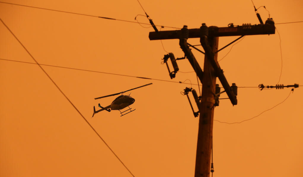 A PG&E helicopter inspects electric lines along Los Alamos Road in Santa Rosa after a power shutdown in 2020.  (CHRISTOPHER CHUNG / The Press Democrat)
