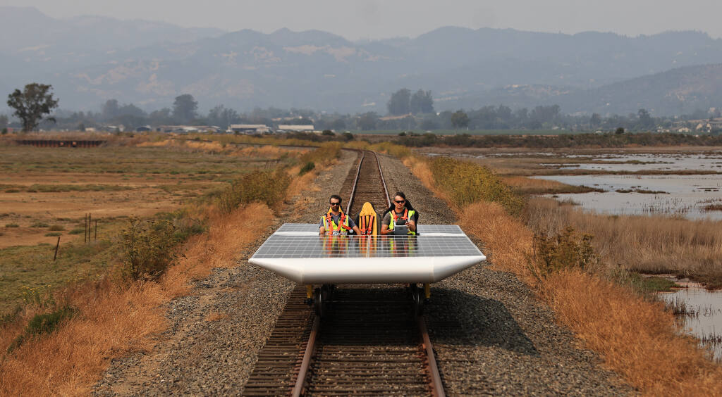 Eric Houston, left, and Marco Fucci di Napoli take the Solar Train out for a spin in the Schellville area of Sonoma County, Friday, Aug. 20, 2021 , where they will attempt a world speed record on Saturday. (Kent Porter / The Press Democrat) 2021