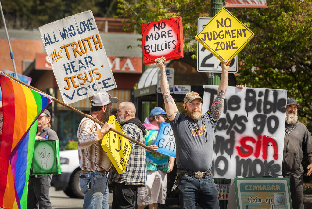 Anti-gay Christian protesters faced off with counterprotesters with pizza boxes with slogans “Love is Love,” and “Not Hate” in downtown Guerneville on Wednesday, March 30, 2022. (John Burgess/The Press Democrat)