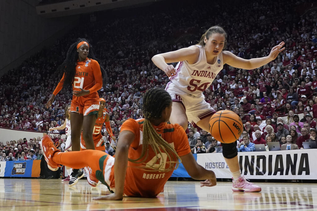 Indiana's Mackenzie Holmes (54) and Jasmyne Roberts (4) battle for a loose ball during the second half of a second-round college basketball game in the women's NCAA Tournament Monday, March 20, 2023, in Bloomington, Ind. (AP Photo/Darron Cummings)