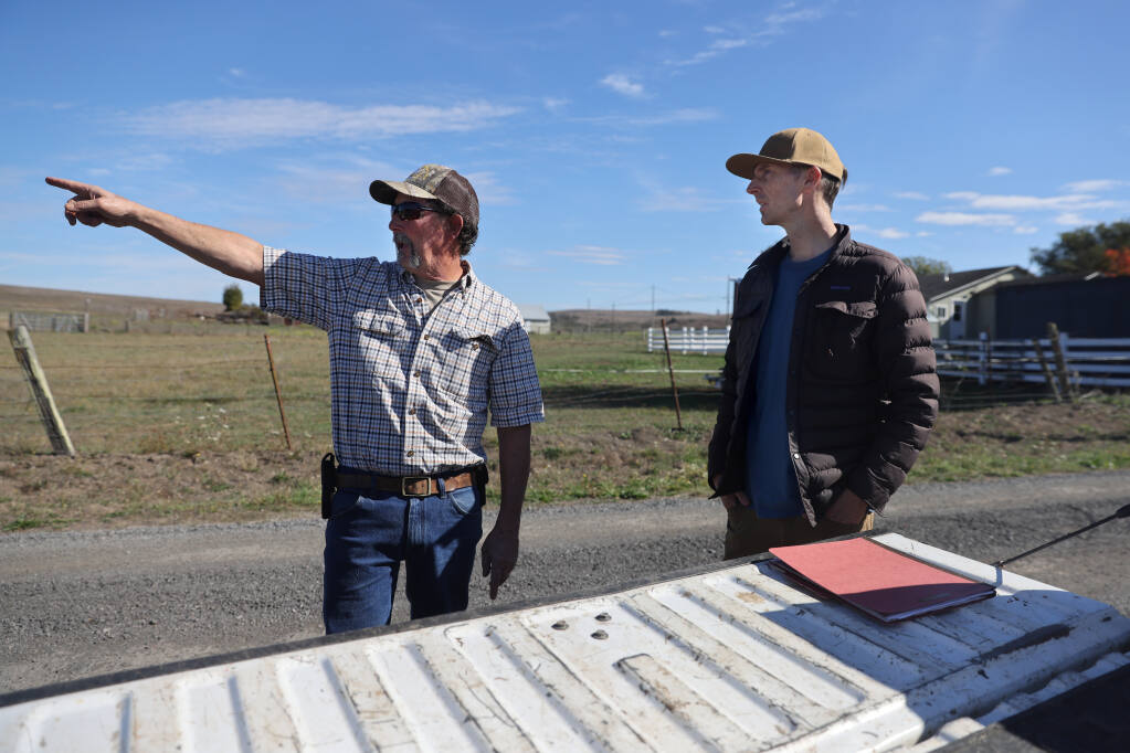William Hart, right, a project manager with Gold Ridge Resource Conservation District, talks with rancher Gary Watts about site improvements on his family's 200 acre parcel in Bodega, Calif. on Tuesday, Oct. 25, 2022. (Beth Schlanker/The Press Democrat)