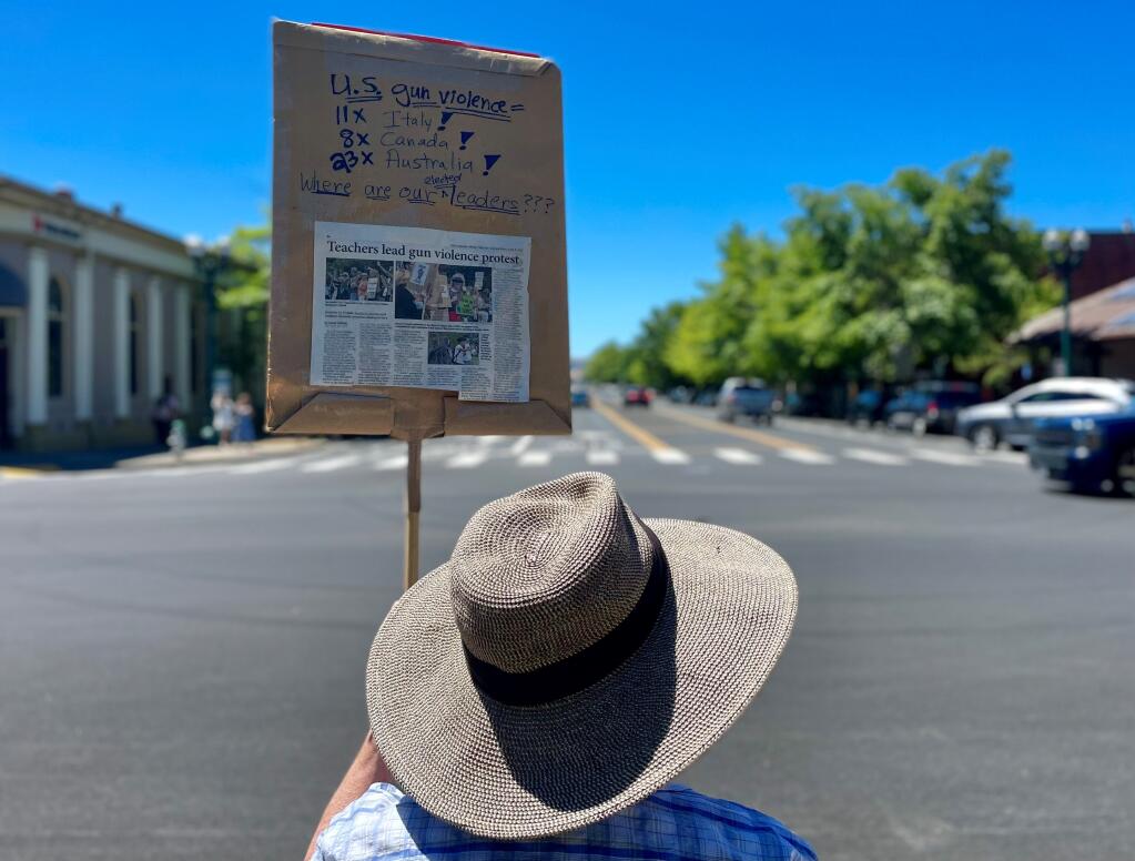 A protester at Sonoma Plaza Saturday waved a sign showing how gun violence in the United States compares to other first world democracies. (Chase Hunter/Index-Tribune)