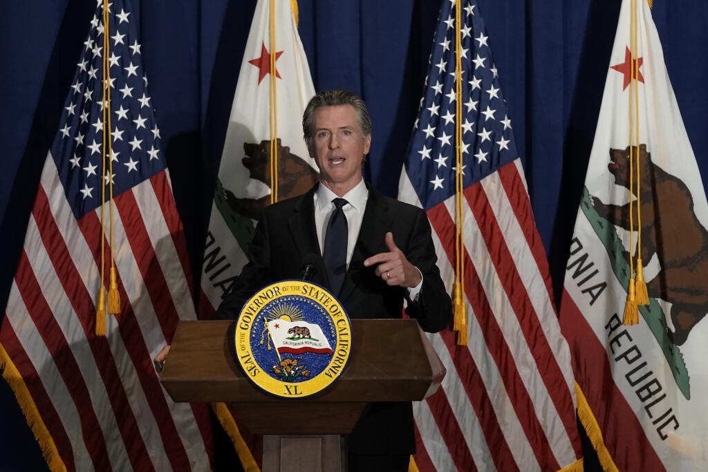 In this file photo, California Gov. Gavin Newsom outlines his 2022-2023 state budget revision during a news conference i in Sacramento, Calif., Friday, May 13, 2022. California is expected have a record surplus. (AP Photo/Rich Pedroncelli)