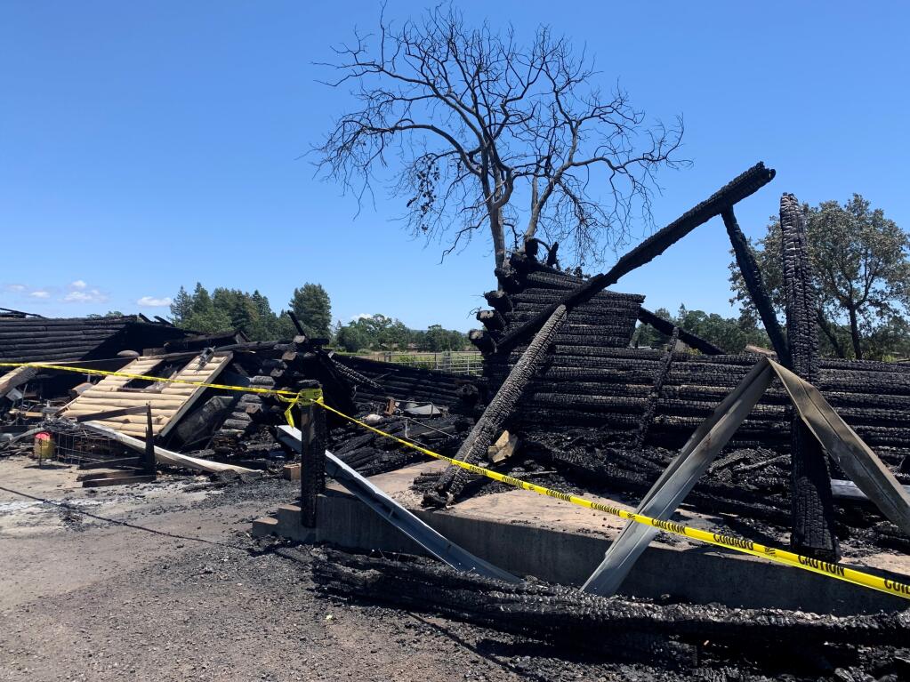 A Santa Rosa log home is visible Wednesday, June 9, 2021, two days after it was destroyed in a fire. Its owner escaped but says he lost nearly everything he owned. (Colin Atagi / The Press Democrat)