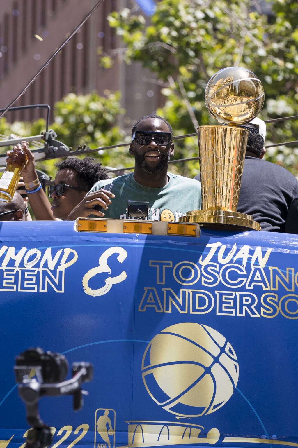 Golden State Warriors' Draymond Green, top, rides next to the Larry O'Brien trophy during the NBA Championship parade in San Francisco, Monday, June 20, 2022, in San Francisco. (AP Photo/John Hefti)