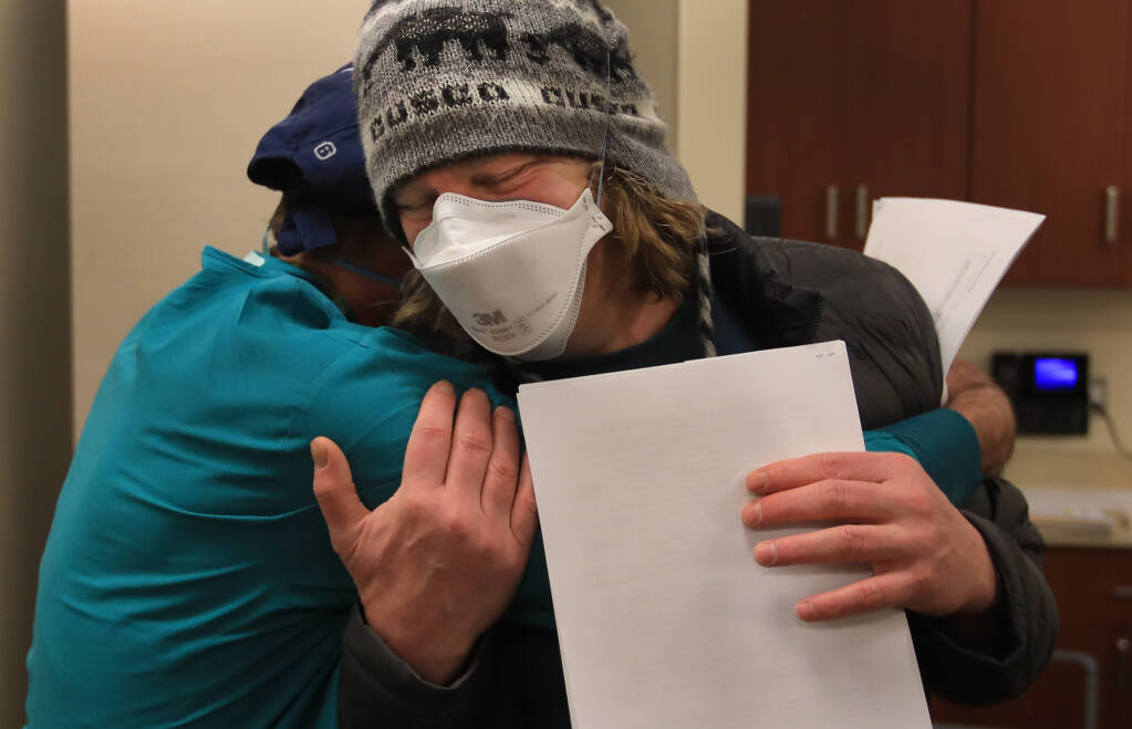 Emergency Department doctors Craig Cohen, front, and Steven Friesse share an embrace after both were vaccinated against COVID-19 at Sutter Santa Rosa Regional Hospital, Sunday, Dec. 20, 2020. (Kent Porter / The Press Democrat) 2020