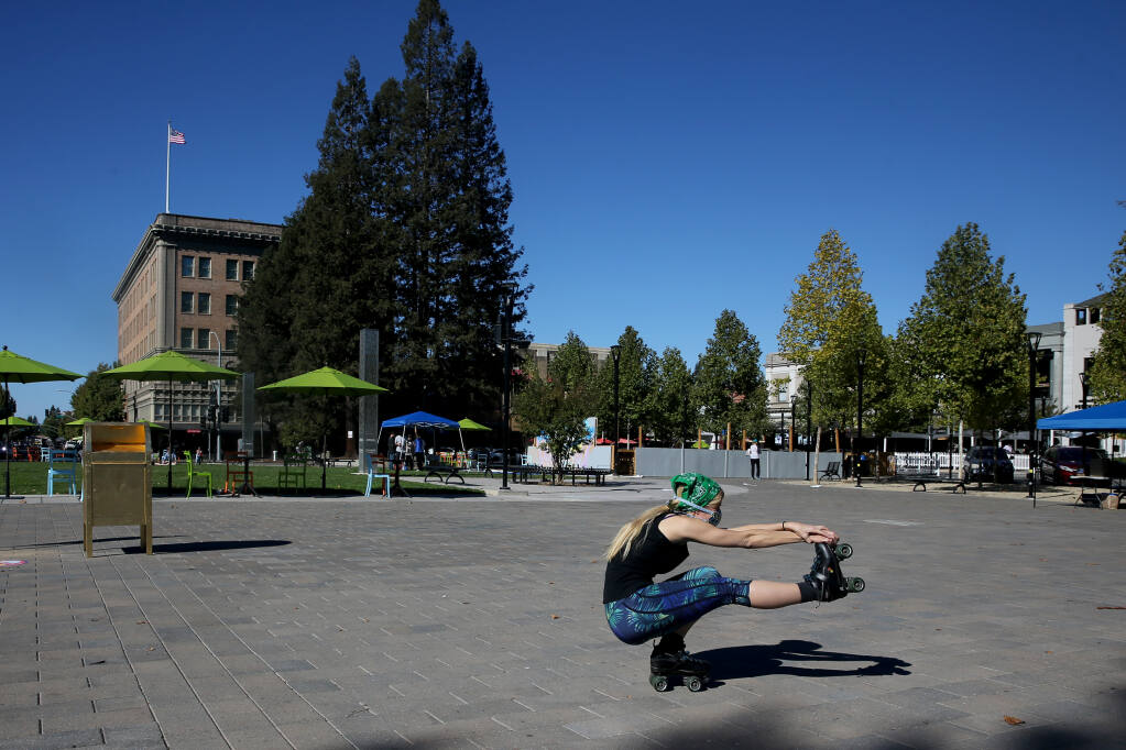 Genevieve M., who enjoys skate dancing at Cal Skate, does tricks during a rally for reopening local family entertainment businesses. Photo taken at Old Courthouse Square in Santa Rosa, Calif., on Sunday, Oct. 11, 2020. (Beth Schlanker/The Press Democrat file)