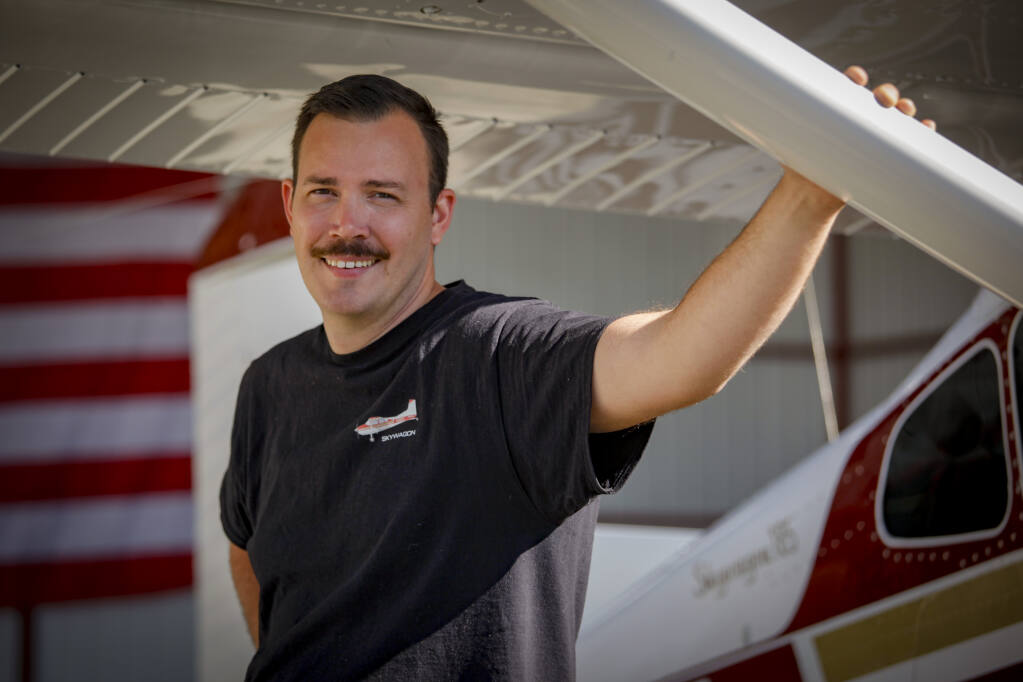 Alex Browne, who recently won the AOPA ePilot’s 2022 Sweepstakes, stands with a Cessna he restored. It is parked in a hangar at the Petaluma Airport. Tuesday, July 26, 2022._Petaluma, CA, USA._(CRISSY PASCUAL/PETALUMA ARGUS-COURIER STAFF)