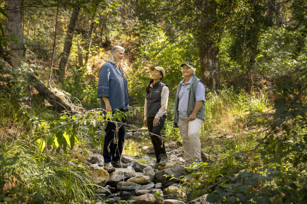 From left, Sonoma County Supervisor Susan Gorin, Agricultural Preservation and Open Space District Stewardship Specialist Leslie Lew and Sonoma County park planner Karen Davis-Brown stop on the banks of Calabazas Creek while on a hike on Friday, July 16, 2021. The nearly 1300 acre property near Glen Ellen was officially transferred to Sonoma County Regional Parks to instigate a general plan for public access in the future. (Photo by John Burgess/The Press Democrat)