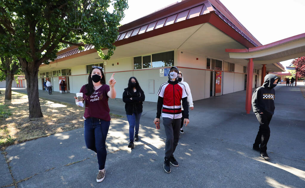 English teacher Jenna Jewell, left, takes her class of freshmen Alessandra Ayala, Chance Stalling, Alijah Baker, and Brandon Simpson on a tour of the Piner High School campus on their first day of in-person learning in Santa Rosa on Monday, April 26, 2021.  (Christopher Chung/ The Press Democrat)