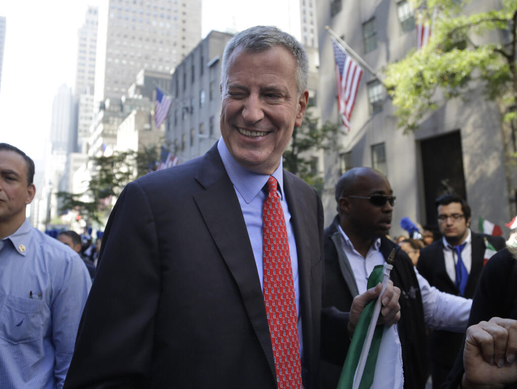 FILE - New York City Mayor Bill de Blasio winks at someone during the Columbus Day Parade in New York, Monday, Oct. 12, 2015. The former New York City Mayor says he will run for Congress in a redrawn district that includes his Brooklyn home. De Blasio announced Friday, May 20, 2022 on MSNBC’s “Morning Joe” that he will seek the Democratic nomination for the 10th Congressional District.   (AP Photo/Seth Wenig, File)