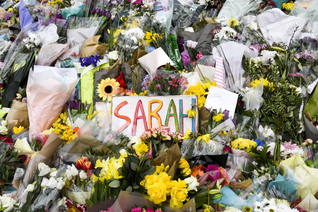 Floral tributes and messages are placed at the bandstand on Clapham Common in London, Saturday, March 20, 2021. Serving British police officer Wayne Couzens stands accused of the kidnap and murder of 33-year-old Sarah Everard, who went missing while walking home in south London on March 3.(AP Photo/Alberto Pezzali)