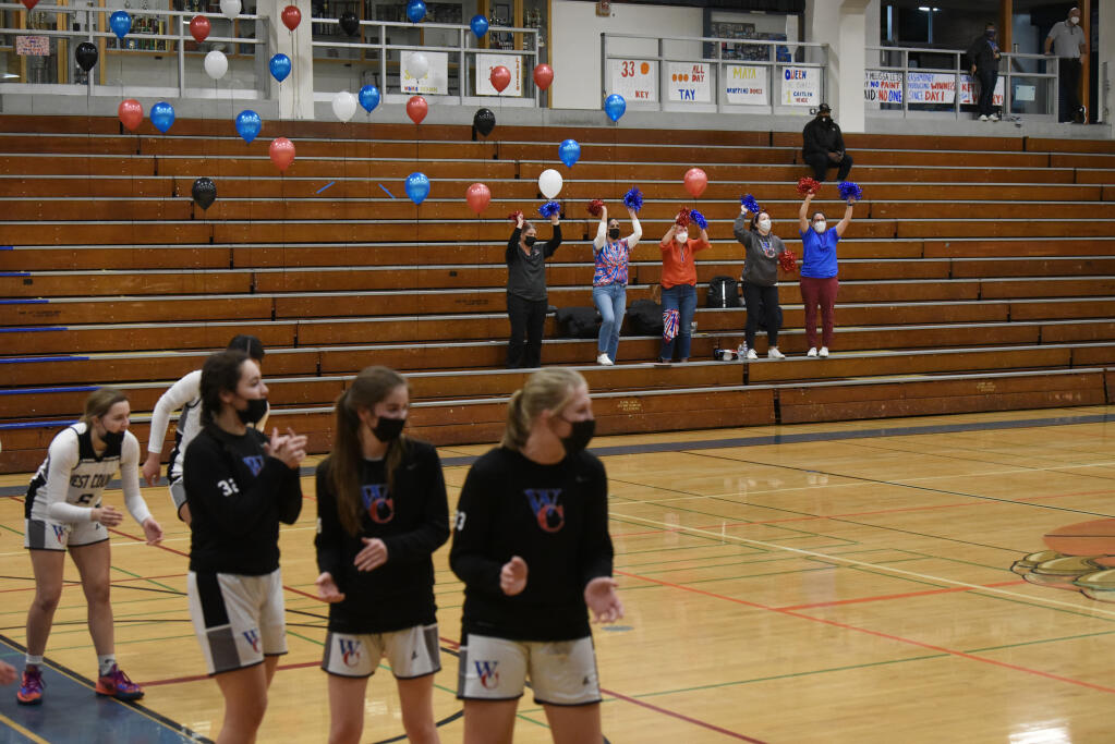 The stands were nearly empty with the one-parent-per-senior rule to comply with a Sonoma County health order on indoor gatherings during the West County High girls basketball game against Cardinal Newman in Sebastopol on Wednesday, Jan. 12, 2022. (Erik Castro / for The Press Democrat)