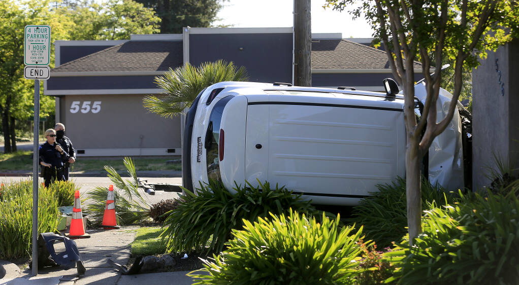 A driver was arrested Tuesday, May 4, 2021, after being pursued by Santa Rosa police after he ran a stop sign and ended up crashing into a business and running away on E Street in Santa Rosa.  (Kent Porter / The Press Democrat)