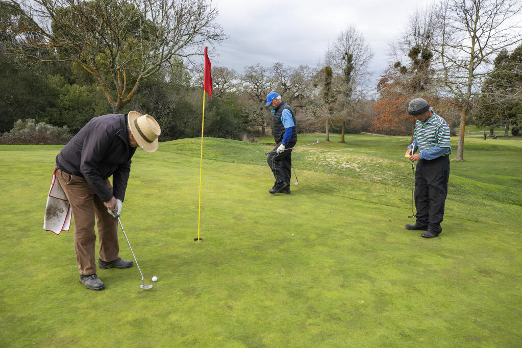From left, golfing buddies Marvin Schouweiler, Fred Rose and Josh Hafner put out on the 6th green at the Bennett Valley Golf Course in Santa Rosa on Monday, February 1, 2021. The Santa Rosa City Council will study the golf course and it's potential future uses at the Tuesday meeting. (Photo by John Burgess/The Press Democrat)