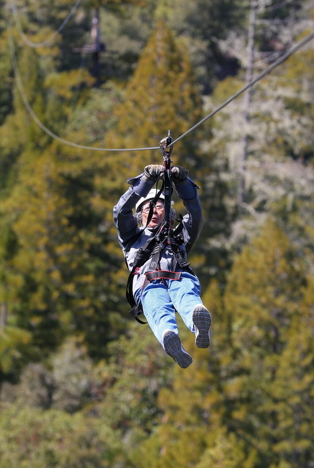 Carmen Taylor, 90, rides a 1,500-foot zipline at Sonoma Zipline Adventures near Occidental on Wednesday, April 19, 2023.  (Christopher Chung/The Press Democrat)