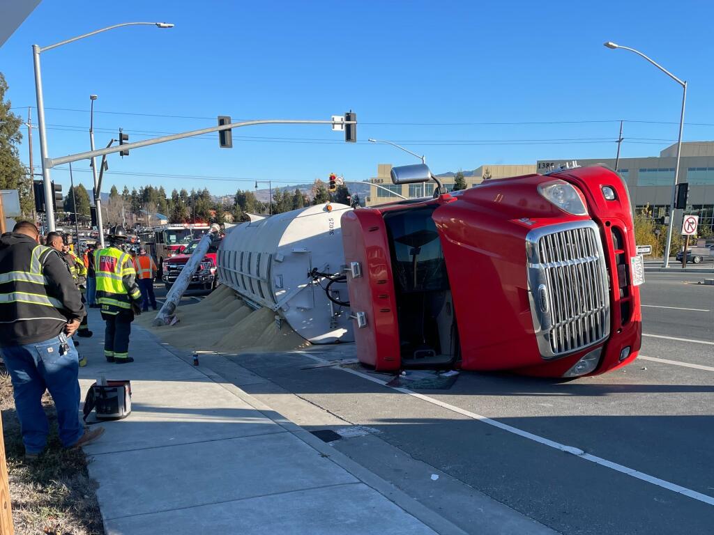 A semitruck carrying chicken feed was attempting to turn onto Petaluma Boulevard North from the offramp when it toppled over Tuesday, Nov. 29, 2022. (Petaluma Police Department)
