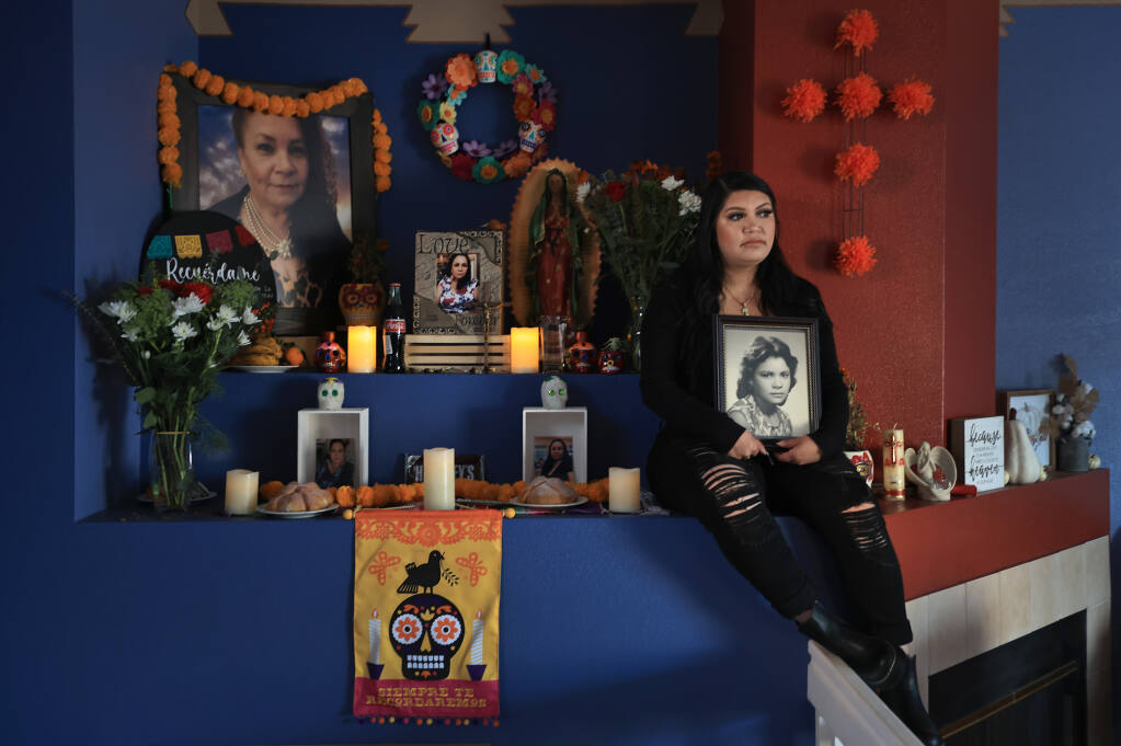 Jessica Gonzalez's mother died of COVID-19 and has kept a Dia de los Muertos offering at her home in Santa Rosa, Saturday, Nov. 27, 2021. (Kent Porter / The Press Democrat) 2021