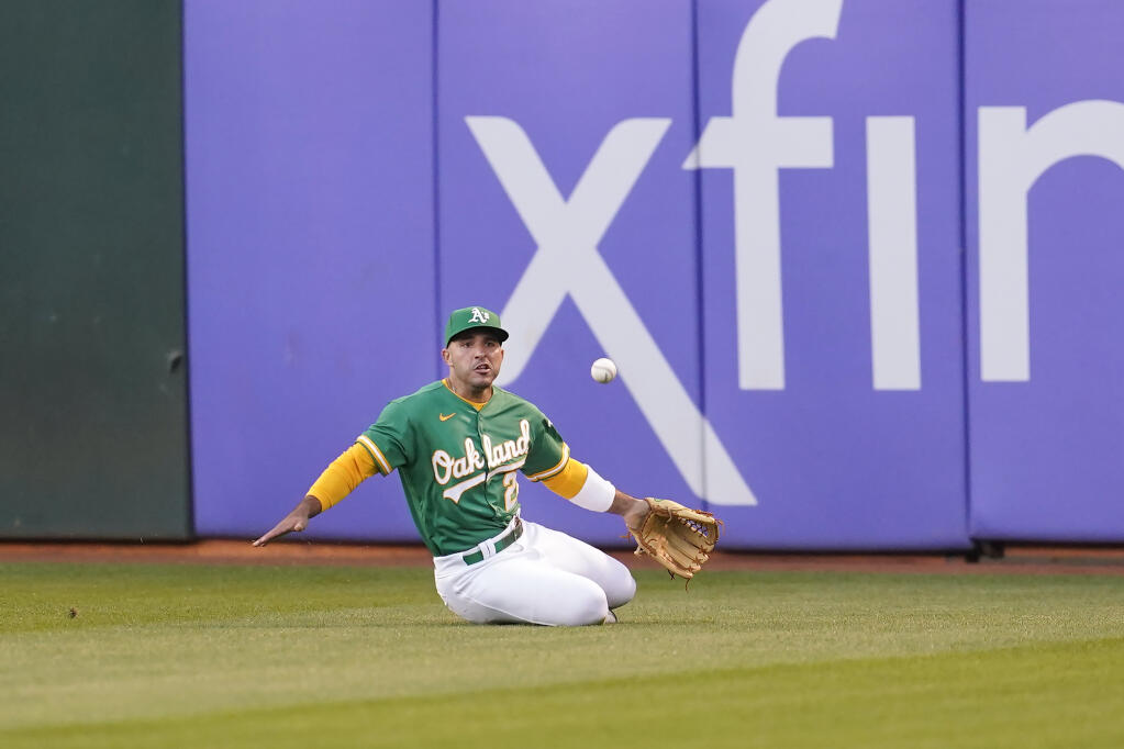 A’s center fielder Ramon Laureano cannot catch a single hit by the Houston Astros’ Aledmys Diaz during the fifth inning in Oakland on Friday, July 8, 2022. (Jeff Chiu / ASSOCIATED PRESS)