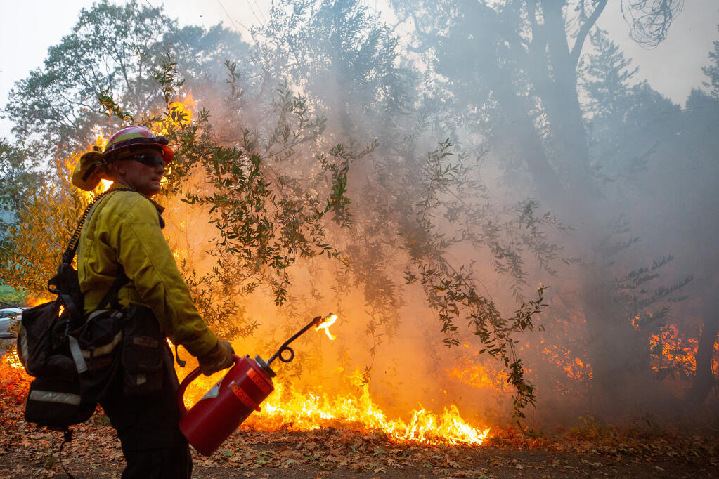 City of Corona fire captain Roger Williams keeps an eye on conditions during a defensive firing operation around homes on Spring Mountain Road near St. Helena, California, on Thursday, Oct. 1, 2020. (Alvin A.H. Jornada / The Press Democrat)