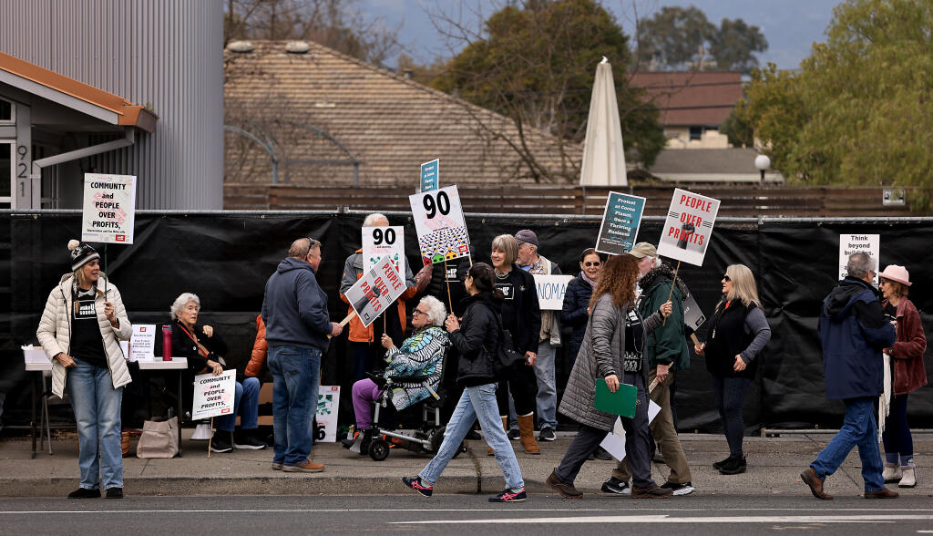 Protesters arrayed against Ken Mattson gather in front of a fenced off property purchased by Mattson at 921 Broadway in Sonoma, Saturday, Feb. 4, 2023.   (Kent Porter / The Press Democrat) 2023